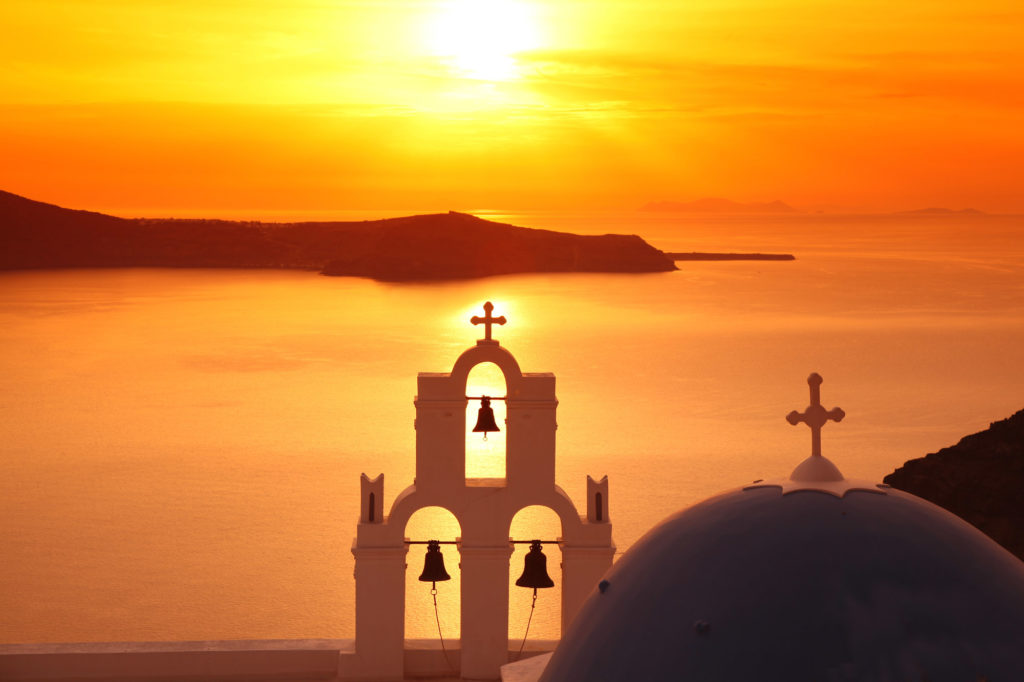 Santorini With Traditional Church In Fira, Greece Old Woman With A Basket Of Apples Outdoor