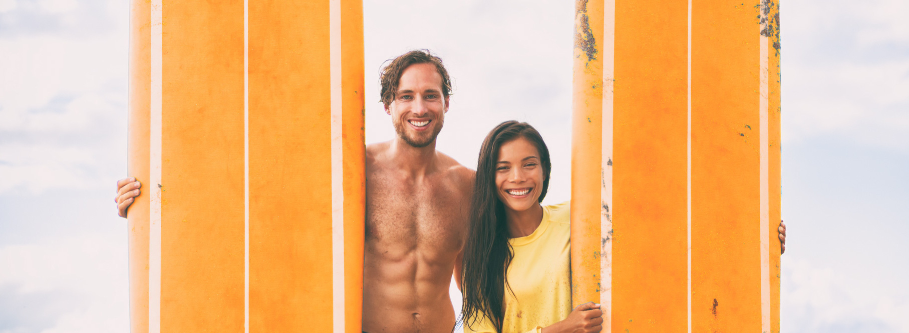 Surfers Couple Happy Holding Orange Surf Boards. Surfing Beach Lifestyle Young Couple On Summer Holidays Banner Panorama.