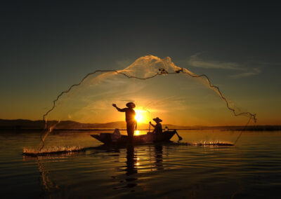 Fisherman Of Asian People At Lake In Action When Fishing During