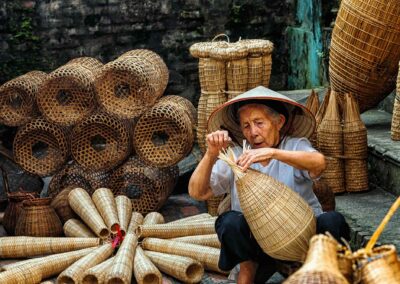 Old Vietnamese Female Craftsman Making The Traditional Bamboo Fi
