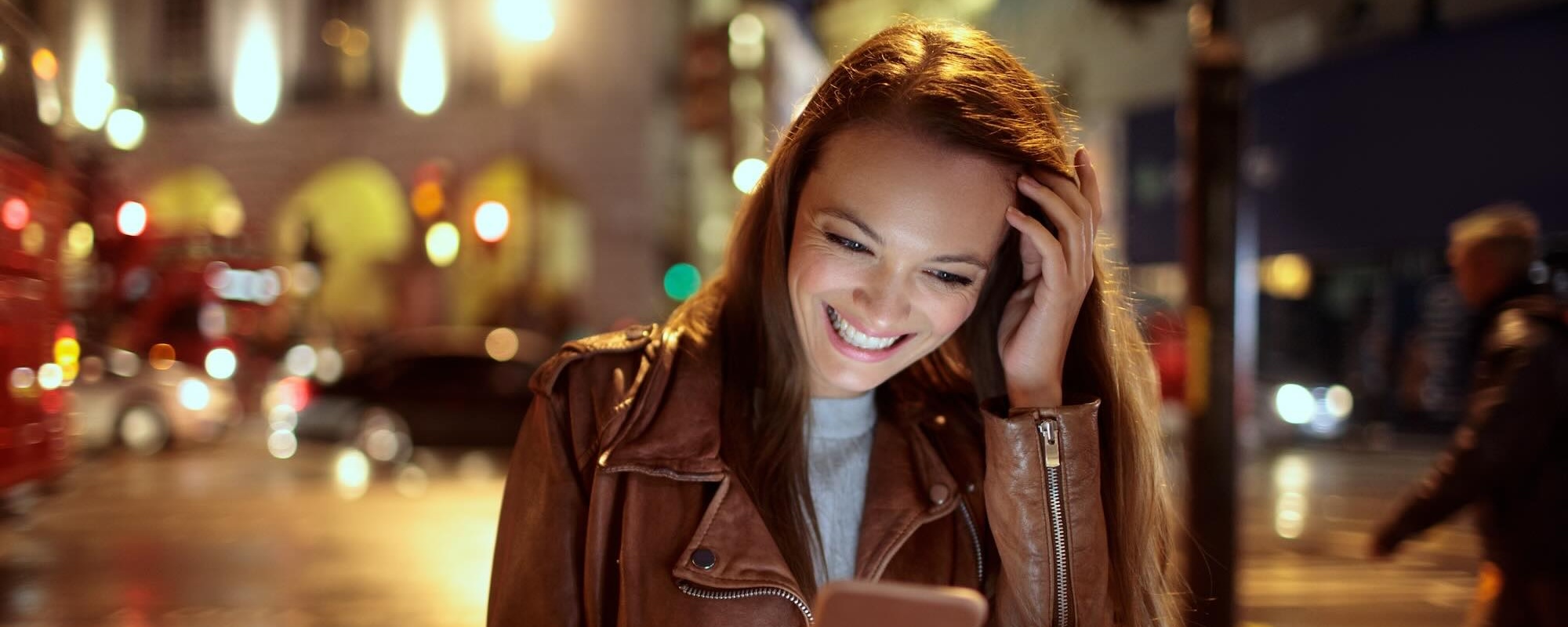 Young Woman Using A Smart Phone While Walking In The City London