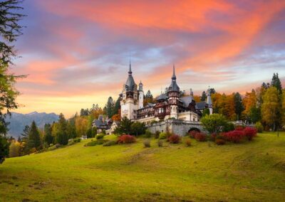 Panorama Of Peles Castle, Romania. Beautiful Famous Royal Castle And Ornamental Garden In Sinaia Landmark Of Carpathian Mountains In Europe At Sunset. Former Home Of The Romanian Royal Family.