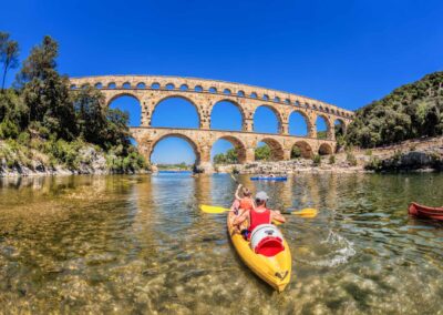 Pont Du Gard With Paddle Boats Is An Old Roman Aqueduct In Prove