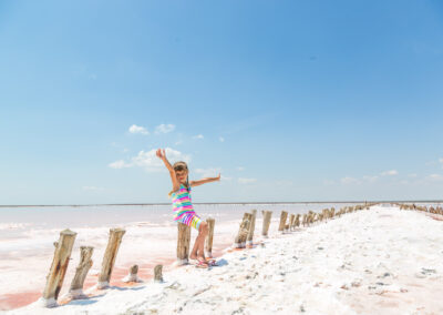 Little Girl On The Background Of Salt Lakes Of The Dead Sea And