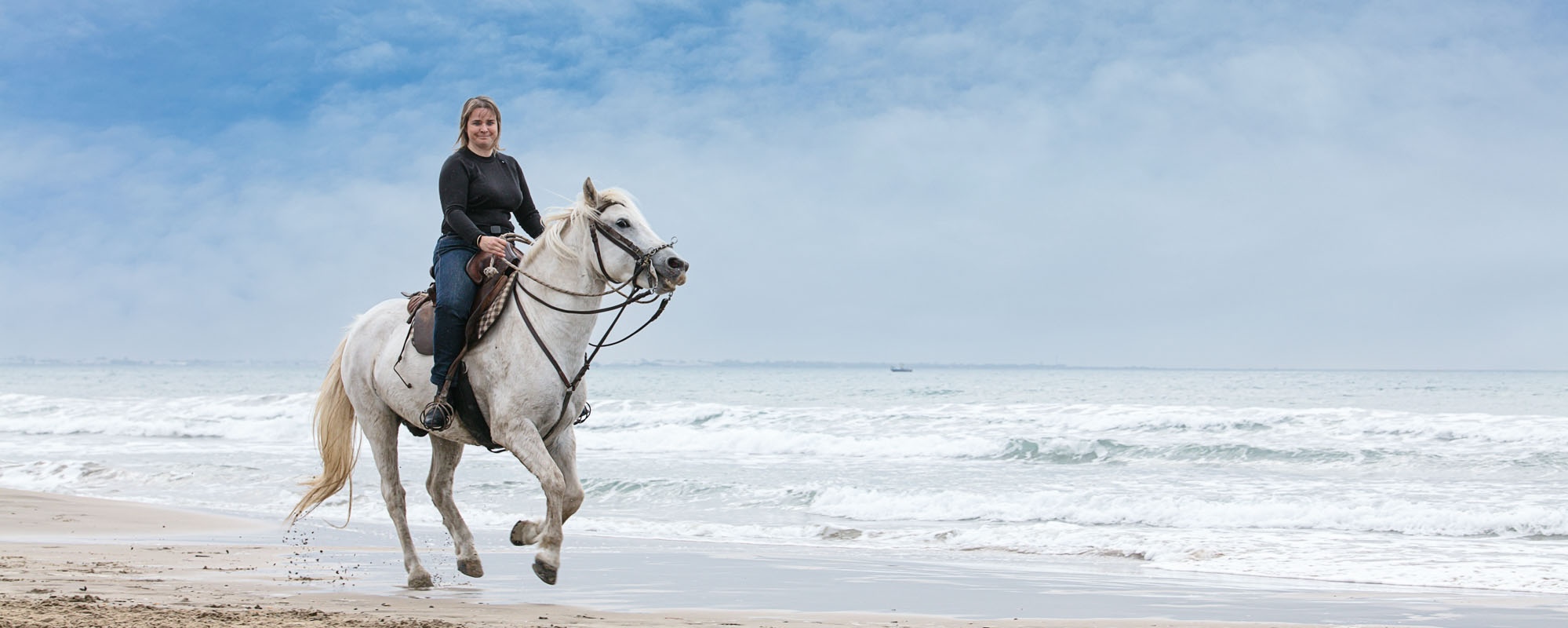 Young Woman On A Horse On The Beach
