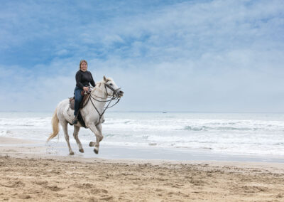 Young Woman On A Horse On The Beach