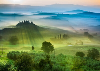 Beautiful View Of Green Fields And Meadows At Sunset In Tuscany