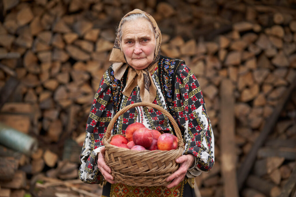 Old Woman With A Basket Of Apples Outdoor
