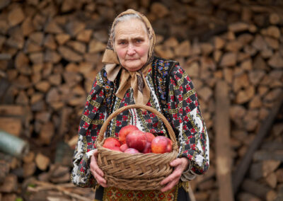 Old Woman With A Basket Of Apples Outdoor