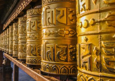 A Prayer Wheels On A Spindle Made From Metal And Wood. Mantra Om