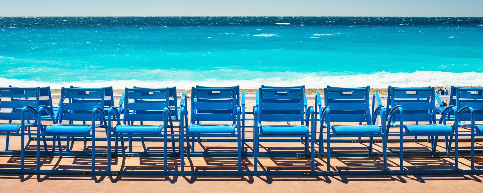 Blue Chairs On The Promenade Des Anglais In Nice, France