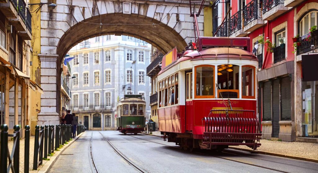 Lisbon, Portugal. Vintage Red Retro Tram On Narrow Bystreet Tram