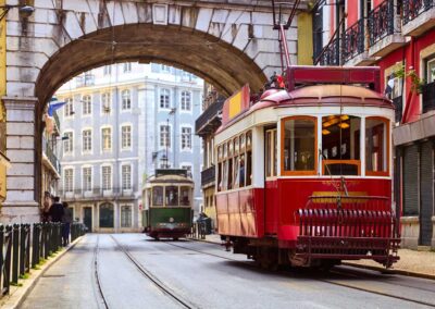 Lisbon, Portugal. Vintage Red Retro Tram On Narrow Bystreet Tram
