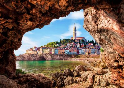 Unusual View With Old Clock Towe In Piran Through A Rock Hole. T